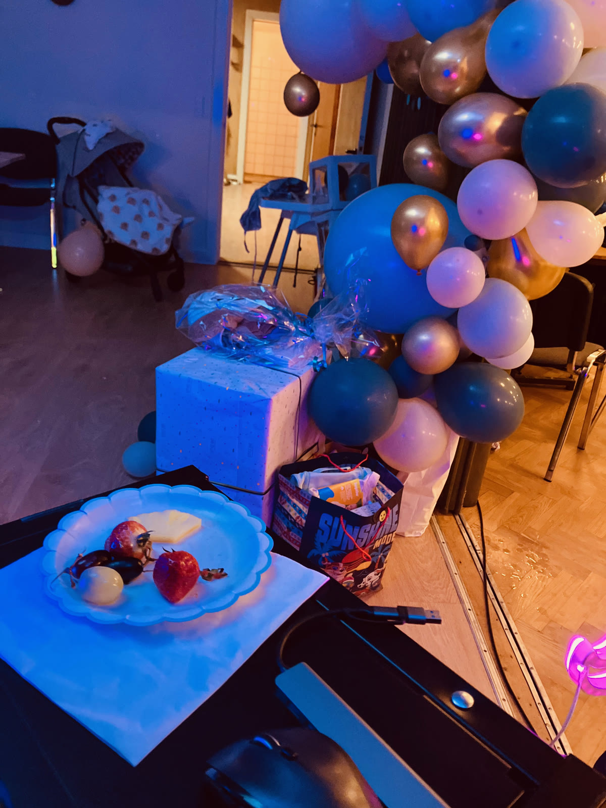 Balloons and fruit by the DJ booth during the party