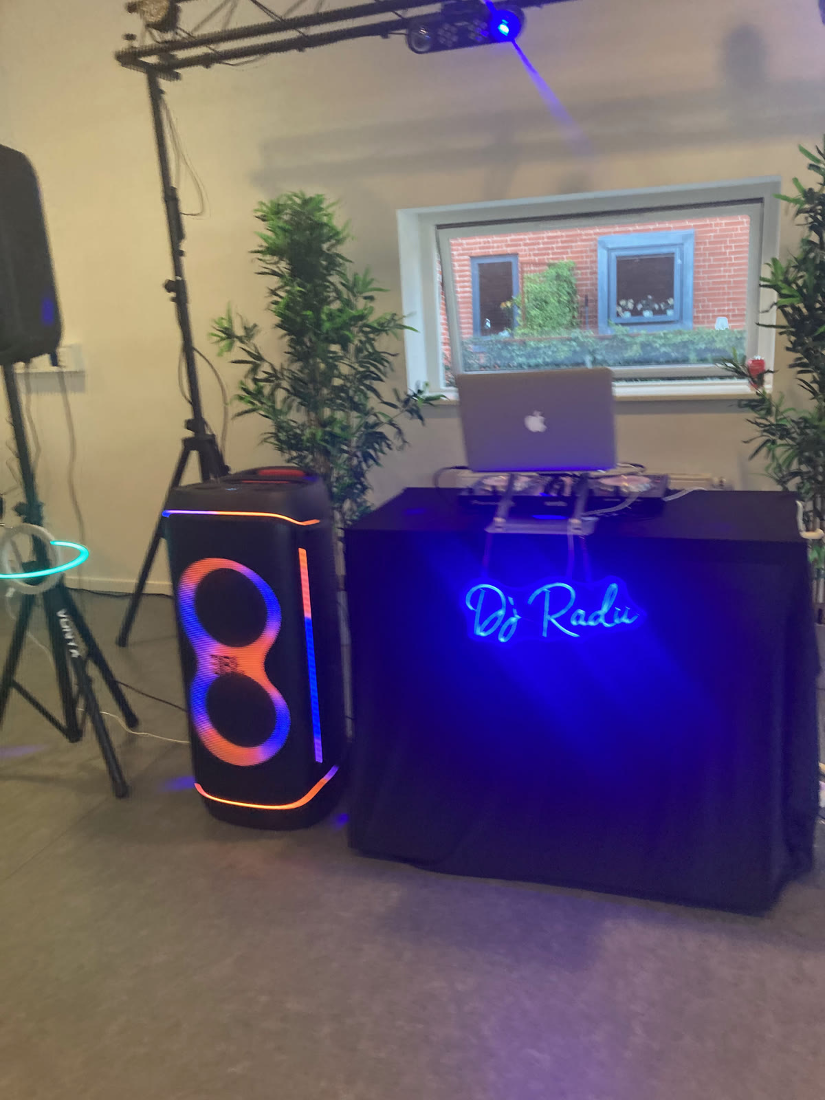 The 'DJ Radu' neon sign in front of the DJ booth